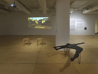Crip installation view. Video projection and three benches.