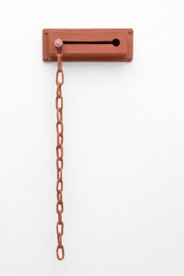Burnt orange colored privacy door lock with chain against a white background.